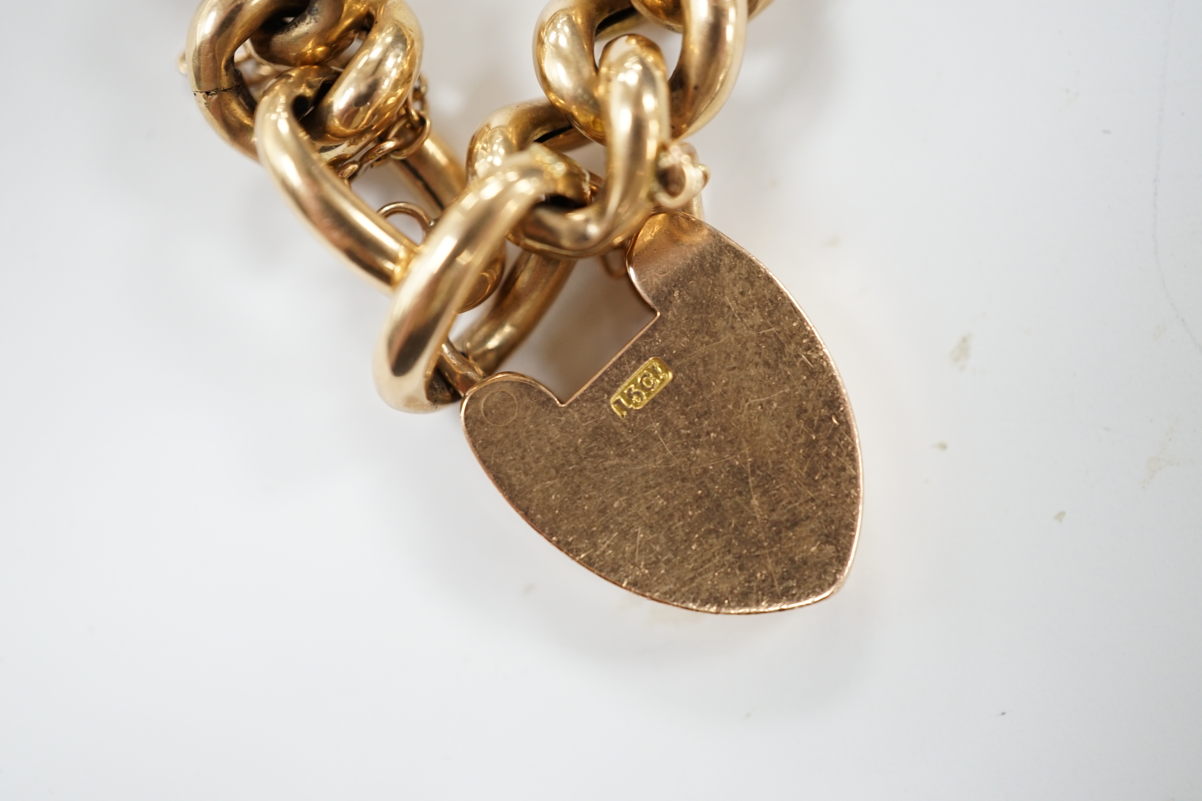An Edwardian 15ct curb link bracelet, with heart shaped padlock clasp, 18cm
